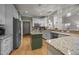 Bright kitchen with white cabinets, stainless steel appliances, granite countertops and wooden flooring at 8116 Mosby Way, Willow Springs, NC 27592