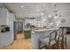 Bright kitchen with white cabinets, stainless steel appliances, granite countertops and breakfast bar at 8116 Mosby Way, Willow Springs, NC 27592