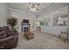 Spacious living room with neutral carpet, fireplace, and open access to kitchen at 8116 Mosby Way, Willow Springs, NC 27592