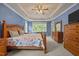 Cozy main bedroom featuring a tray ceiling, plush carpet and large windows providing natural light at 8116 Mosby Way, Willow Springs, NC 27592