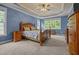 Cozy main bedroom featuring a tray ceiling, plush carpet and large windows providing natural light at 8116 Mosby Way, Willow Springs, NC 27592