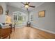Bright office space with a large arched window, hardwood floors, and a ceiling fan at 8116 Mosby Way, Willow Springs, NC 27592