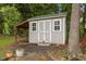 Well-maintained storage shed with double doors and additional covered storage space at 8116 Mosby Way, Willow Springs, NC 27592