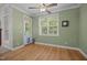 Bright sun room with hardwood flooring, ceiling fan, and a glass door leading to the outside at 8116 Mosby Way, Willow Springs, NC 27592