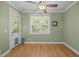 Bright sun room with hardwood flooring, ceiling fan, and a glass door leading to the outside at 8116 Mosby Way, Willow Springs, NC 27592