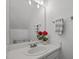 Bathroom featuring white vanity and a mirror with decorative flowers at 8151 Rhiannon Rd, Raleigh, NC 27613
