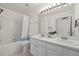 Bathroom with double sinks, tub/shower combo, and decorative accents at 8151 Rhiannon Rd, Raleigh, NC 27613