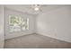 Bright bedroom with neutral carpet, ceiling fan, and large window that provides great natural light at 8151 Rhiannon Rd, Raleigh, NC 27613
