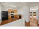 Spacious kitchen boasting wood cabinets, stainless steel appliances, and hardwood flooring at 8151 Rhiannon Rd, Raleigh, NC 27613