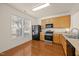Bright kitchen featuring modern appliances, wood cabinets, and ample counter space at 8151 Rhiannon Rd, Raleigh, NC 27613