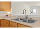Modern kitchen countertop featuring stainless steel sink, wood cabinets, and contemporary faucet at 8151 Rhiannon Rd, Raleigh, NC 27613