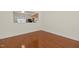 View from the living room looking into the kitchen area with laminate floors at 8151 Rhiannon Rd, Raleigh, NC 27613