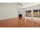 View of the living room with a ceiling fan, fireplace, and access to the backyard at 8151 Rhiannon Rd, Raleigh, NC 27613