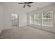 Bright main bedroom with neutral carpet, ceiling fan, and an ensuite bathroom at 8151 Rhiannon Rd, Raleigh, NC 27613