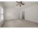 Neutral carpet and ceiling fan in the main bedroom provide an inviting space at 8151 Rhiannon Rd, Raleigh, NC 27613