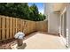 Concrete backyard patio with a wooden fence and a potted flower at 8151 Rhiannon Rd, Raleigh, NC 27613