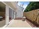 Concrete backyard patio with sliding glass doors and a door to a utility room at 8151 Rhiannon Rd, Raleigh, NC 27613