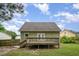 Home's backyard featuring a wooden deck and green siding at 816 Kimpton Ct, Fuquay Varina, NC 27526
