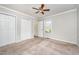 Bedroom with a ceiling fan, closet and view to backyard at 816 Kimpton Ct, Fuquay Varina, NC 27526
