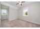 Neutral bedroom featuring two windows and a ceiling fan at 816 Kimpton Ct, Fuquay Varina, NC 27526