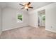 Spacious bedroom with multiple windows and a ceiling fan at 816 Kimpton Ct, Fuquay Varina, NC 27526