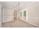 Bright dining room boasting wood-look flooring, elegant lighting, and access to the backyard at 816 Kimpton Ct, Fuquay Varina, NC 27526