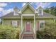 Inviting home entrance with a pink front door, dormer windows, and manicured landscaping at 816 Kimpton Ct, Fuquay Varina, NC 27526