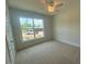 Bright bedroom with a ceiling fan, a large window, and plush carpeting at 85 Bald Cypress Ln, Youngsville, NC 27596