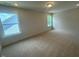 Neutral bedroom featuring two windows offering natural light with neutral carpet at 85 Bald Cypress Ln, Youngsville, NC 27596