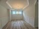 Dining room featuring natural light, a tray ceiling, and decorative wainscoting at 85 Bald Cypress Ln, Youngsville, NC 27596