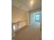 Bright hallway leading to a room with a view, featuring neutral carpeting and natural light at 85 Bald Cypress Ln, Youngsville, NC 27596