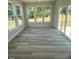 Bright sunroom with large windows offering serene views and hardwood flooring at 85 Bald Cypress Ln, Youngsville, NC 27596