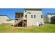 A view of the backyard featuring a screened in porch, siding, basement door and lush green grass at 966 Airedale Trl, Garner, NC 27529