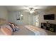 Comfortable bedroom features a ceiling fan, mirror, television and decorative pillows on the bed at 966 Airedale Trl, Garner, NC 27529