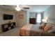 Bedroom features a ceiling fan, television, a comfy bed with decorative pillows, and a dresser at 966 Airedale Trl, Garner, NC 27529