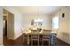 Traditional dining room with a chandelier, six chairs, and decorative curtains at 966 Airedale Trl, Garner, NC 27529