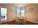 Cozy dining area featuring a round table, white chairs, and ample natural light from the nearby windows at 966 Airedale Trl, Garner, NC 27529