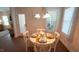Bright dining room with a round table set for a meal, adjacent to a door leading outside at 966 Airedale Trl, Garner, NC 27529
