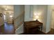 Inviting foyer features staircase, piano, and open view to living spaces with hardwood floors and natural light at 966 Airedale Trl, Garner, NC 27529