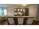 Charming kitchen features granite counters, stainless appliances, gray cabinets, and a breakfast bar with seating at 966 Airedale Trl, Garner, NC 27529
