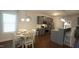 Dining area and kitchen showcasing stainless steel appliances, gray cabinets, and a breakfast bar at 966 Airedale Trl, Garner, NC 27529