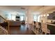 Open-concept living room showcasing a stone fireplace, hardwood floors, and a seamless flow to the kitchen at 966 Airedale Trl, Garner, NC 27529