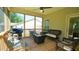 Relaxing screened-in porch features comfortable wicker furniture, grill, a fire pit table, and wooded views at 966 Airedale Trl, Garner, NC 27529