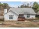 The home's backyard features a wooden deck and stone retaining walls at 100 W Acres Cres, Cary, NC 27519