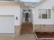 Welcoming entrance with brick steps, stylish front door, and attached garage entrance at 100 W Acres Cres, Cary, NC 27519