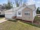 Charming home with brick accents, white siding, a well-maintained lawn, and a spacious two-car garage at 100 W Acres Cres, Cary, NC 27519