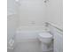 Clean, all-white tiled bathroom features a tub/shower combo and modern toilet and sink fixtures at 1002 Willow Drive # 63, Chapel Hill, NC 27514