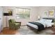 Tastefully designed bedroom featuring a comfortable bed, chair, and hardwood floors at 1002 Willow Drive # 63, Chapel Hill, NC 27514