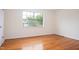 Bright bedroom with hardwood floors, a large window, and fresh white trim at 1002 Willow Drive # 63, Chapel Hill, NC 27514