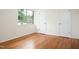 Bright bedroom with hardwood floors, a large window, and ample closet space at 1002 Willow Drive # 63, Chapel Hill, NC 27514